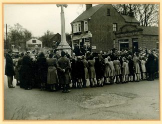 A gathering at the War Memorial and in the background The Clock House Cafe  c.1952 | Castle Point Council