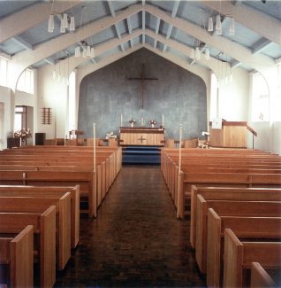 A more recent picture of the interior, however the hand built pews have been replaced with chairs.