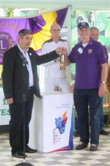 Councillor Stephen Castle with Lion John Sanderson. Torchbearer Ian Groome is in the background. | Jenny Day