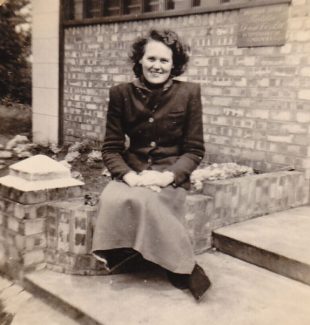 Peggy Eason sitting on the front steps of  Turtella Dressmakers | Denise Neale