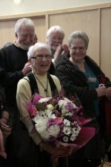 Local artist Iris Sugg receives a bouquet of flowers. Behind her on the top right is another local artist Cliff Messitter Local artist Iris Sugg receives a bouquet of flowers. Behind her on the top right is another local artist Cliff Messitter | Rachel Day