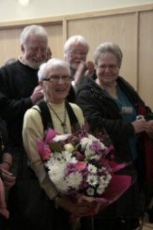 Local artist Iris Sugg receives a bouquet of flowers. Behind her on the top right is another local artist Cliff Messitter | Rachel Day