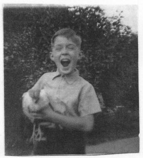 Holding my pet chicken which was eventually taken by a fox. 1954 | John Garnham