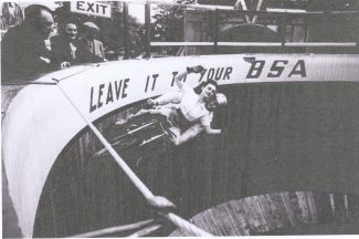 Sixteen year old Maureen Swift riding with Tornado Smith around the wall of death attraction in the Southend Kursaal to promote BSA motorcycles (c.1949) | corbis